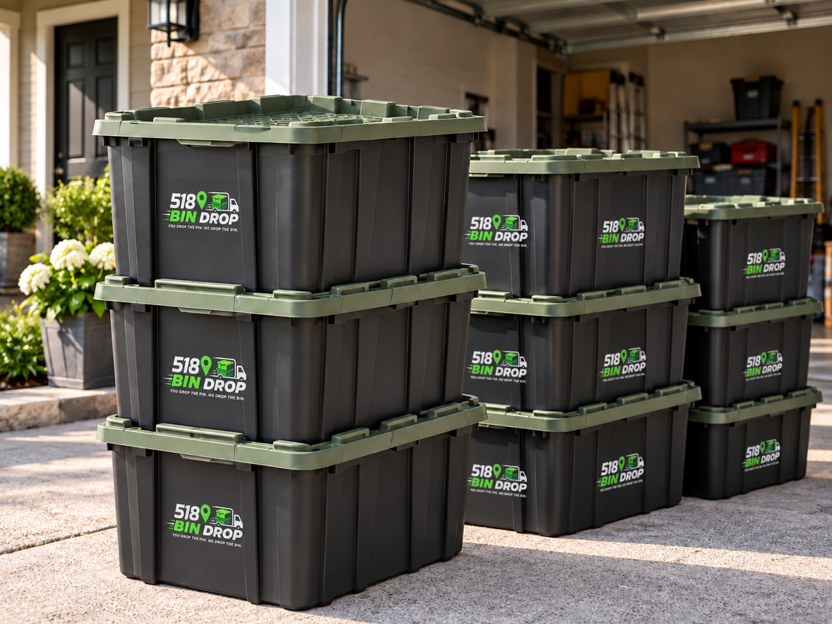Apartment Drop 20-bin rental with grouped 518 Bin Drop reusable black moving bins and military green lids.